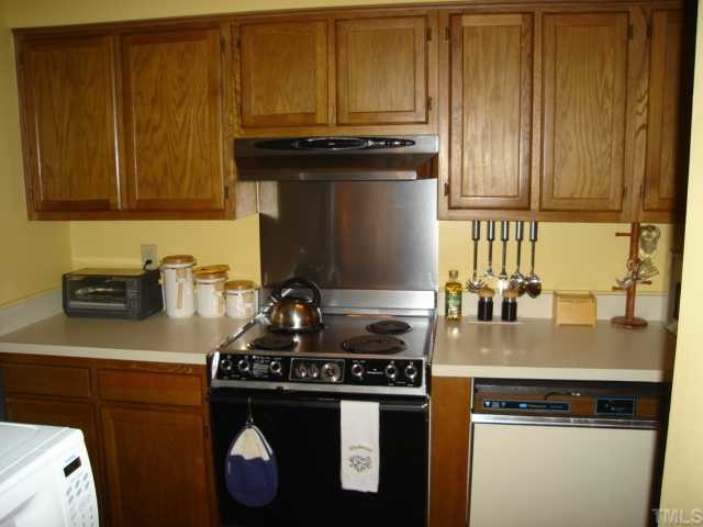 2215 Alpine Road Durham, NC 27707 - Photo 4 of 7 Kitchen with new flooring. All major appliances remain(Range, Refrigerator, Washer, Dryer, Dishwasher.