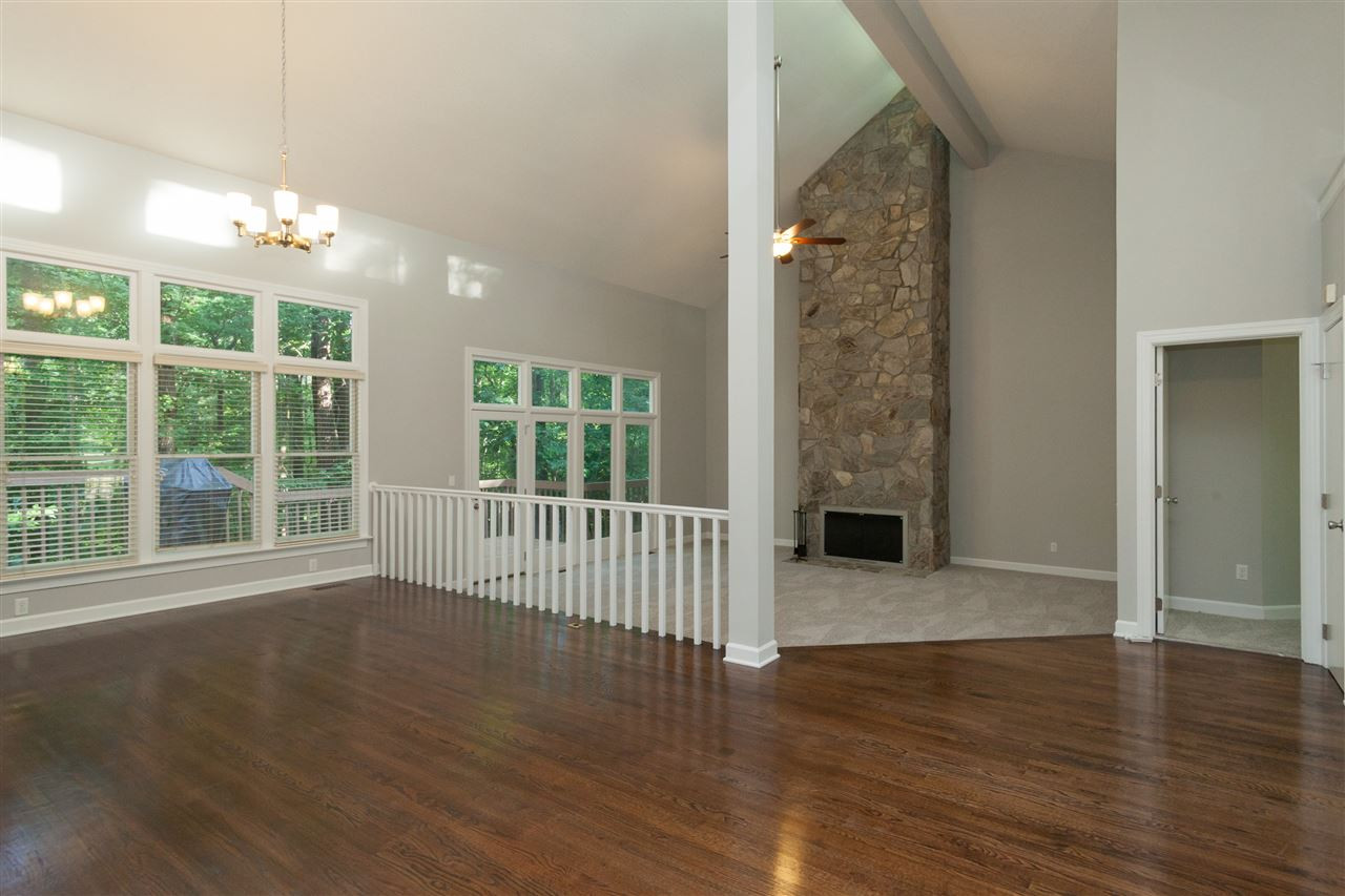 5700 Dunstan Court Raleigh, NC 27613 - Photo 25 of 25 Beautiful refinished hardwood floors, vaulted ceiling and soaring fireplace highlight the dining room and family room. New carpet and paint throughout the home. Open Floor Plan