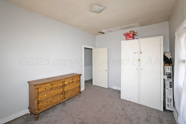 a bathroom with a toilet a sink a mirror and a window