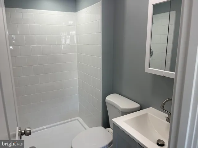 a white toilet sitting next to a bathroom sink