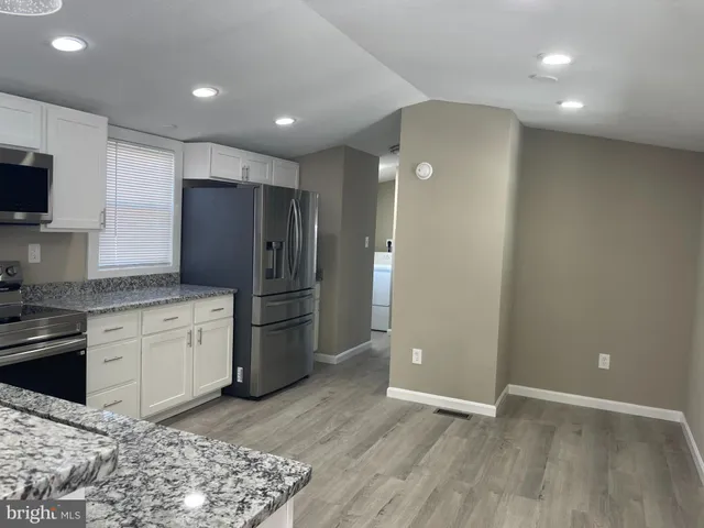 a kitchen with a refrigerator and a sink