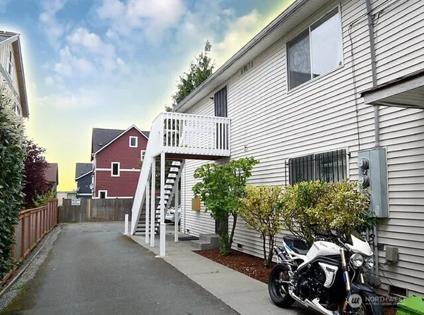 a view of a house with a yard and sitting area