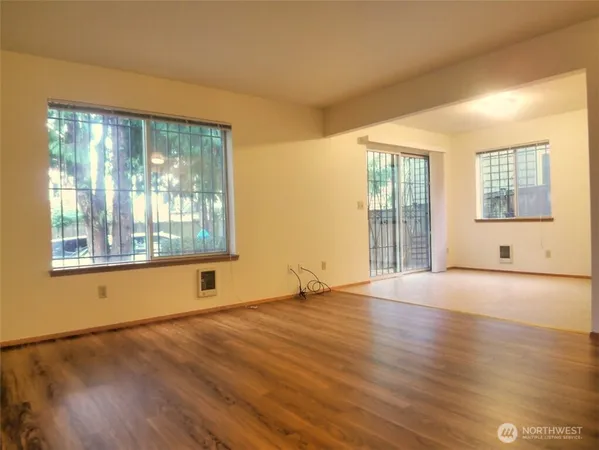 a view of an empty room with wooden floor
