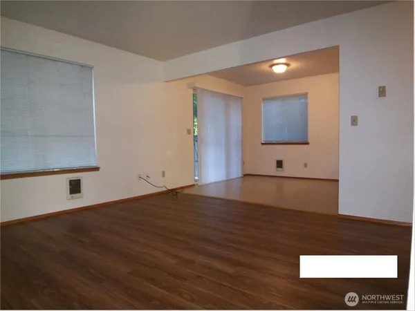 a view of a kitchen with wooden floor