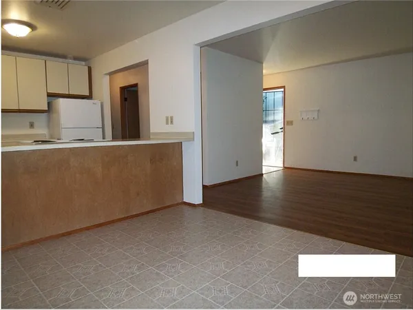 a kitchen with stainless steel appliances granite countertop a refrigerator sink and white cabinets