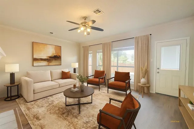 a living room with furniture and a large window