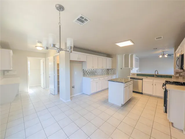 a room with a cabinets and a window