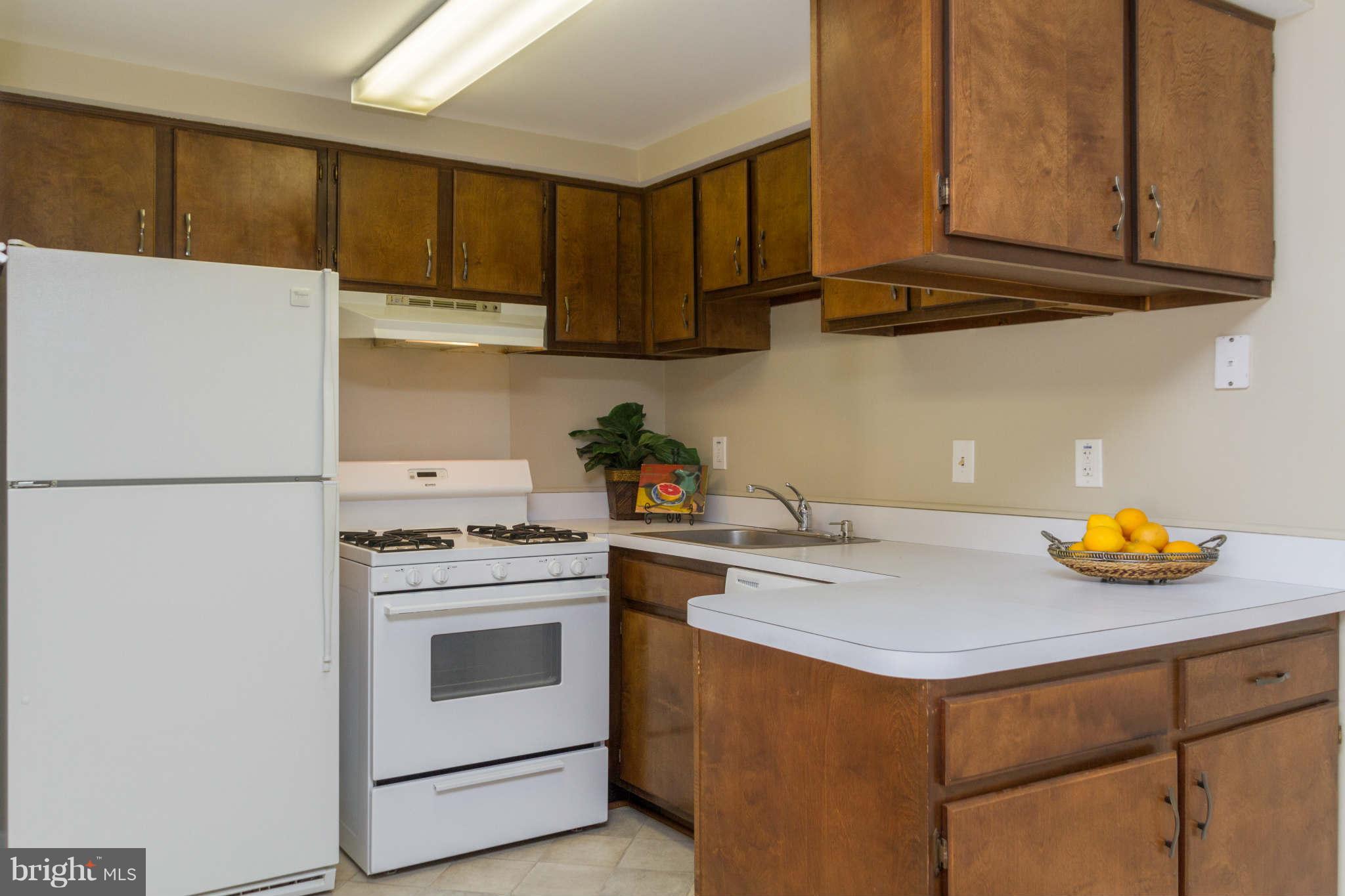 2572 Riva Road, Unit 20B Annapolis, MD 21401 - Photo 7 of 18 a kitchen with stainless steel appliances granite countertop a sink a stove and refrigerator