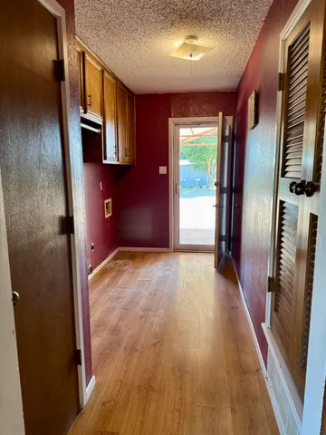 a view of a hallway with wooden floor