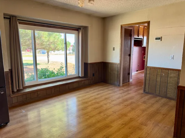 a view of an empty room with closet and windows