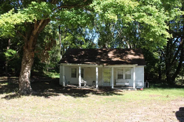 a view of a house with a yard covered in snow