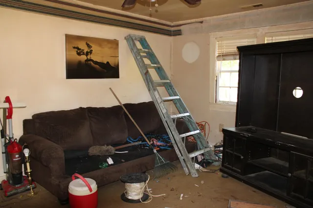 a living room with furniture and a mirror