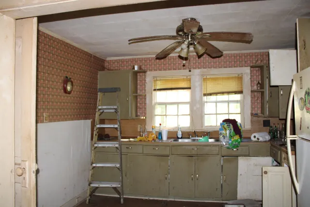 a kitchen with a sink appliances and a window