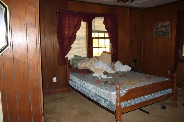 a bed sitting in a room next to a window