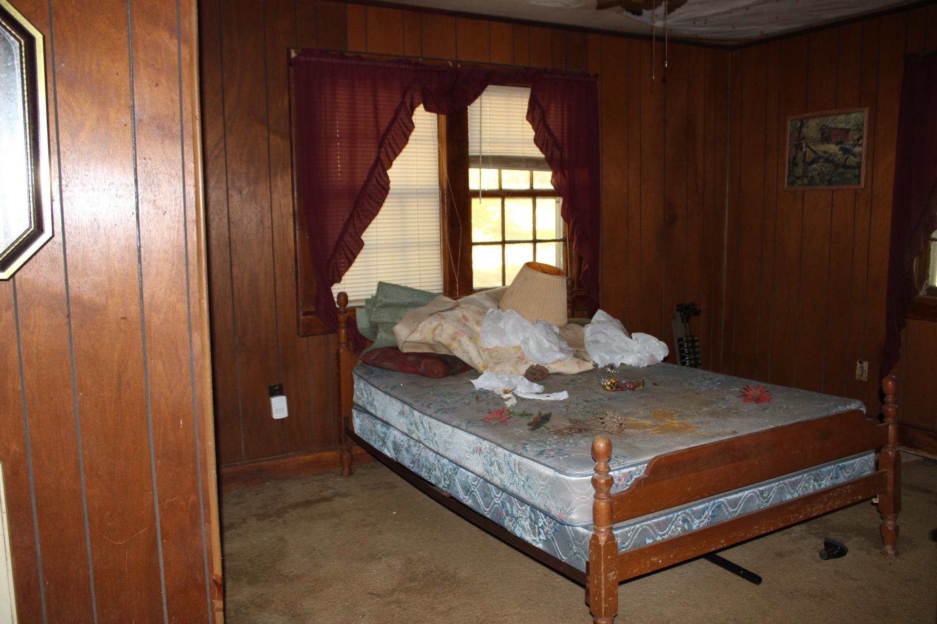 1364 Highway 59 Covington, TN 38019 - Photo 9 of 11 a bed sitting in a room next to a window
