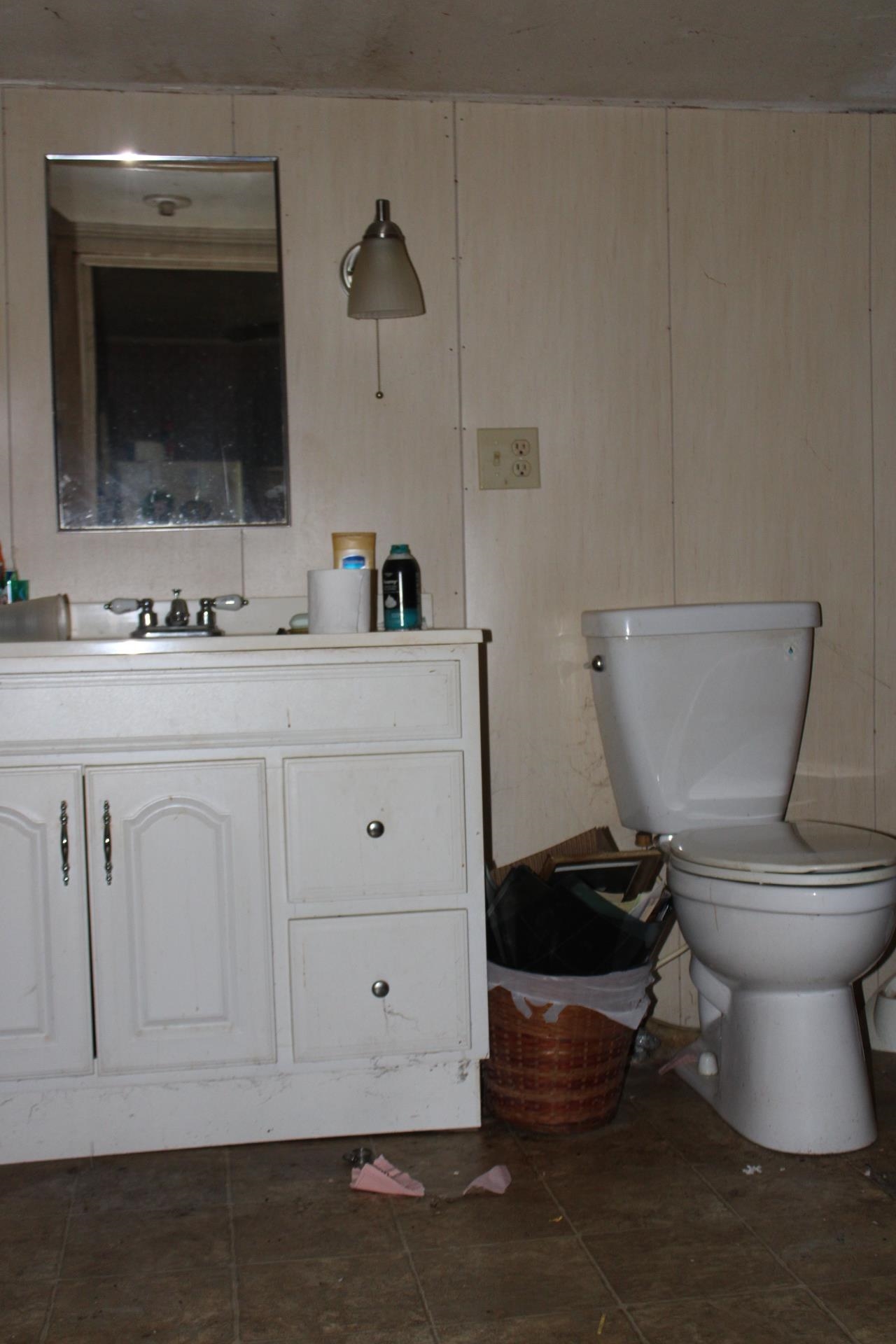 1364 Highway 59 Covington, TN 38019 - Photo 10 of 11 a bathroom with a toilet a sink and mirror