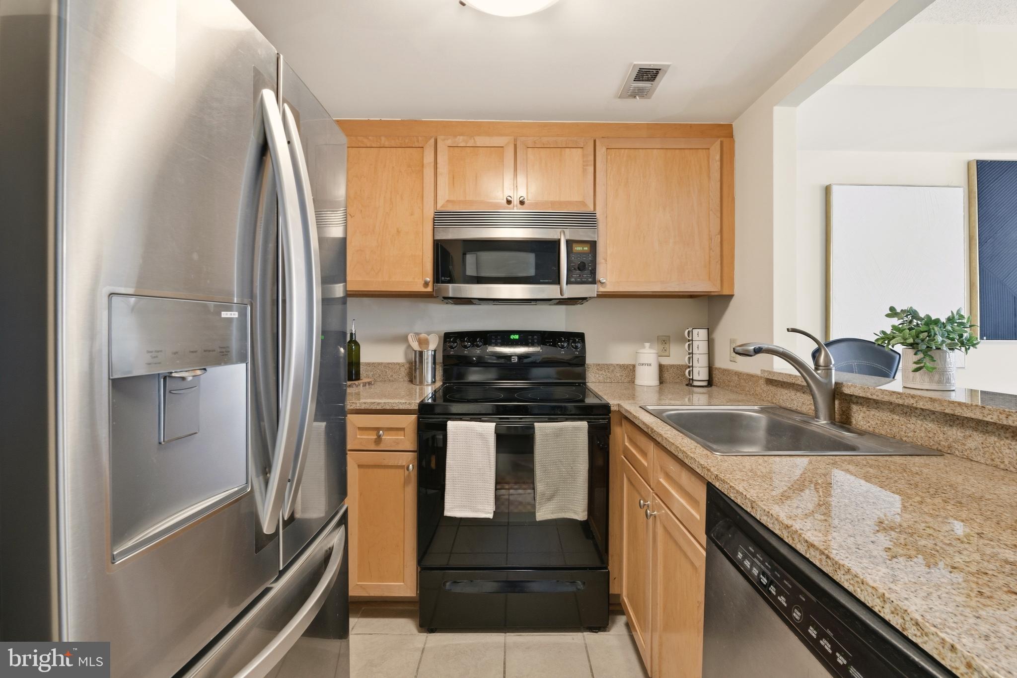 1150 K Street Northwest, Unit 1109 Washington, DC 20005 - Photo 10 of 33 a kitchen with a sink stove and refrigerator