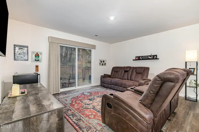 a dining room with furniture and wooden floor