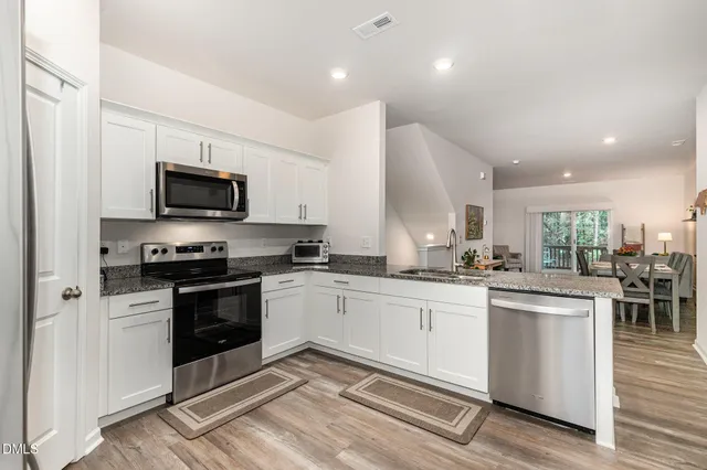 a view of a dining room with furniture and wooden floor