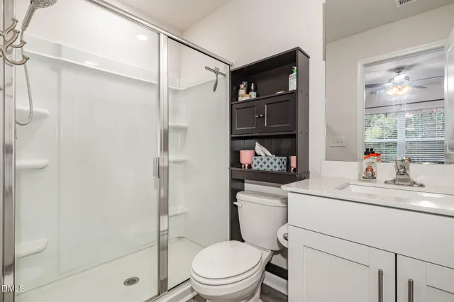 a living room with furniture a flat screen tv and a floor to ceiling window