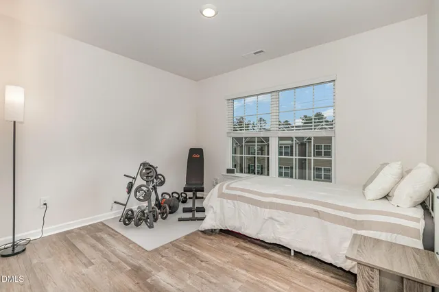a bedroom attached with a bed and a chandelier