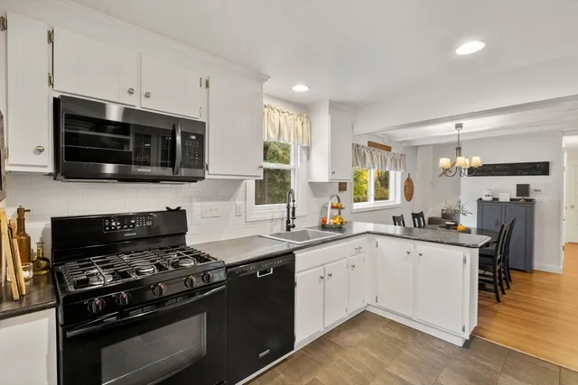 a kitchen with stainless steel appliances a sink stove and microwave