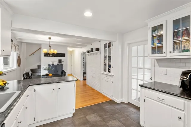 a kitchen with granite countertop a sink and cabinets