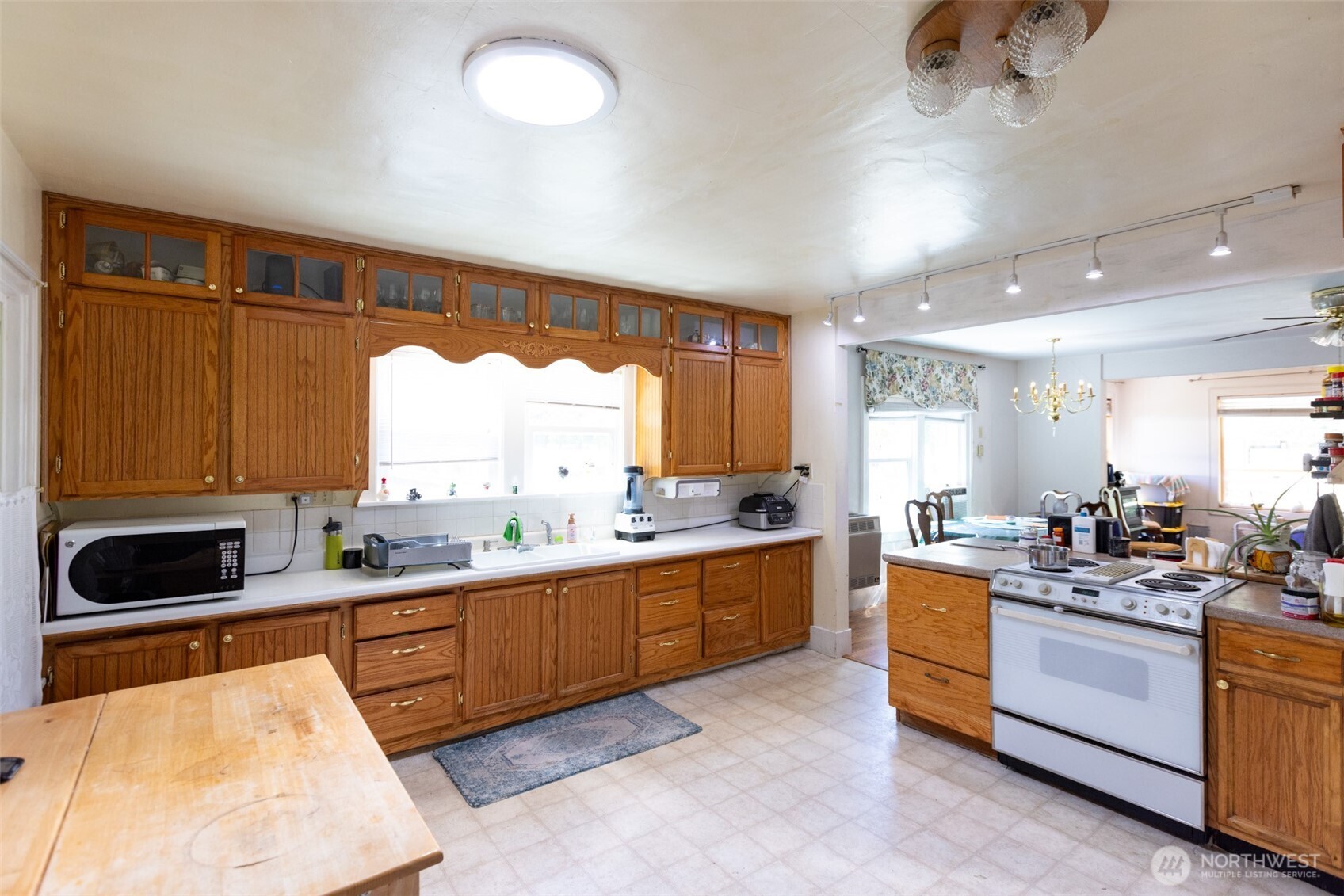 992 Highway 142 Lyle, WA 98635 - Photo 11 of 40 a large kitchen with kitchen island a sink stainless steel appliances and cabinets