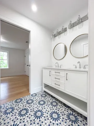 a bathroom with a sink vanity and a mirror