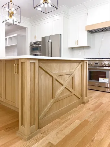 a kitchen with stainless steel appliances granite countertop a stove a refrigerator and cabinets