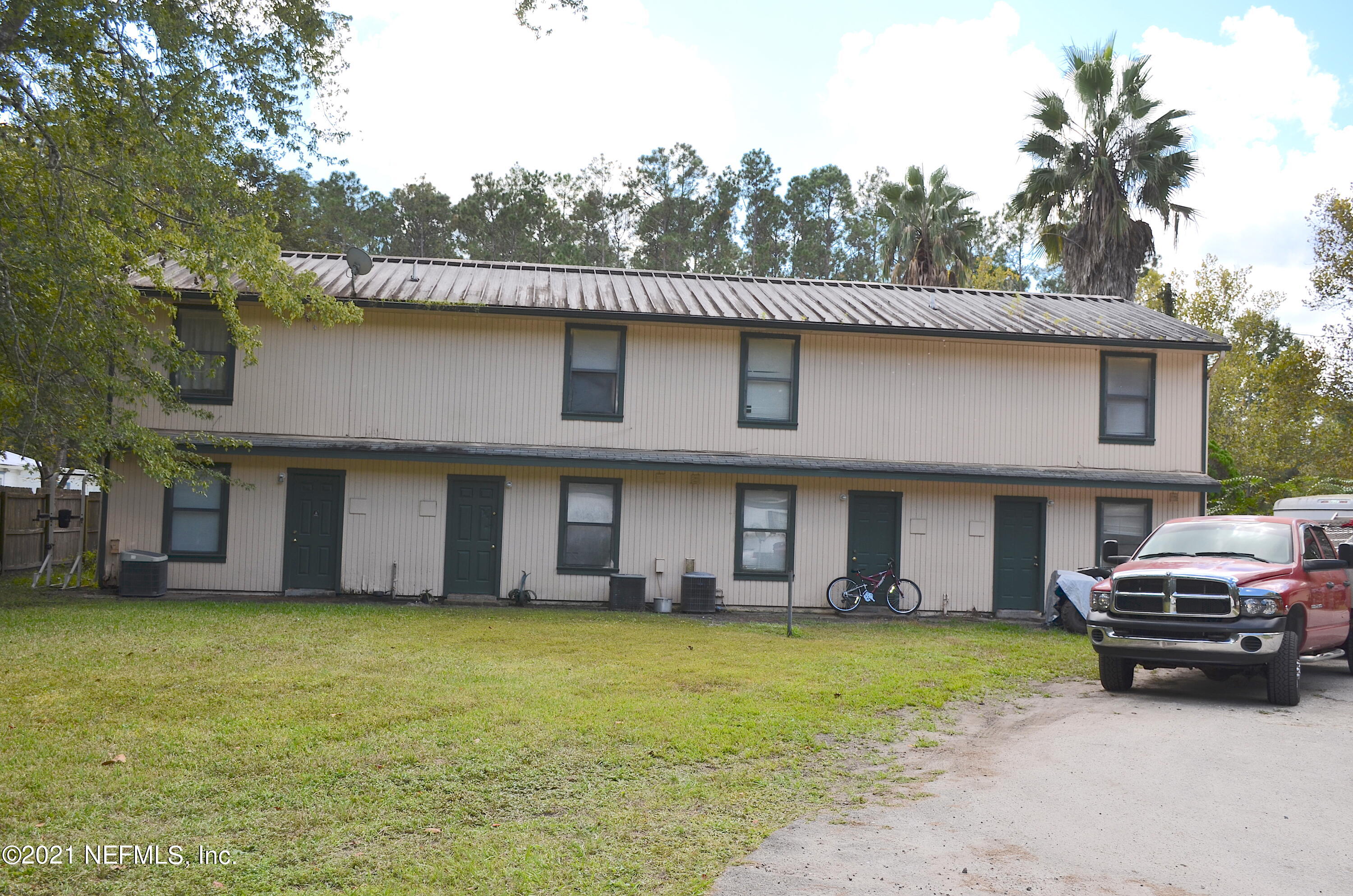 681 Rainer Road, Unit 3 Baldwin, FL 32234 - Photo 13 of 28 a front view of a house with a garden and plants