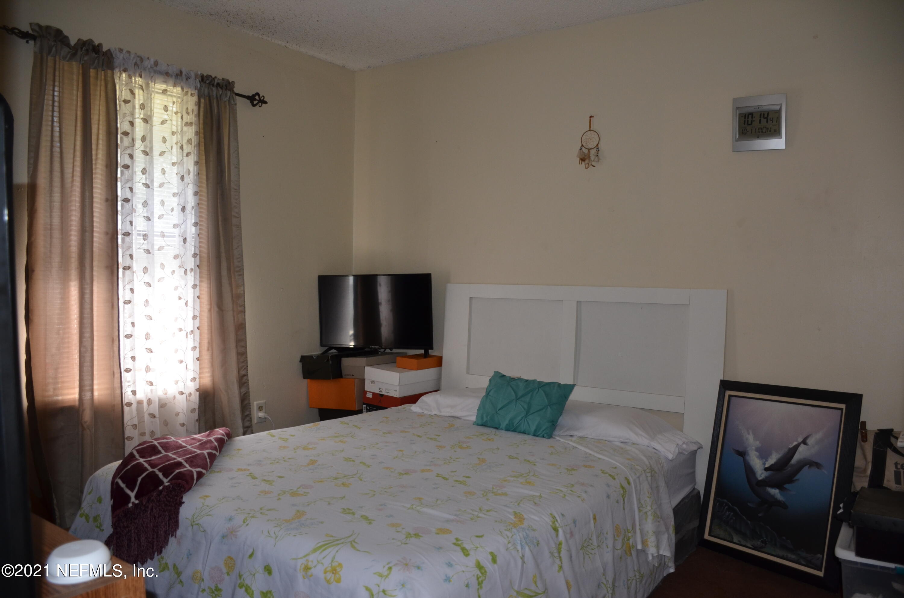 681 Rainer Road, Unit 3 Baldwin, FL 32234 - Photo 20 of 28 a bedroom with a bed and wooden floor