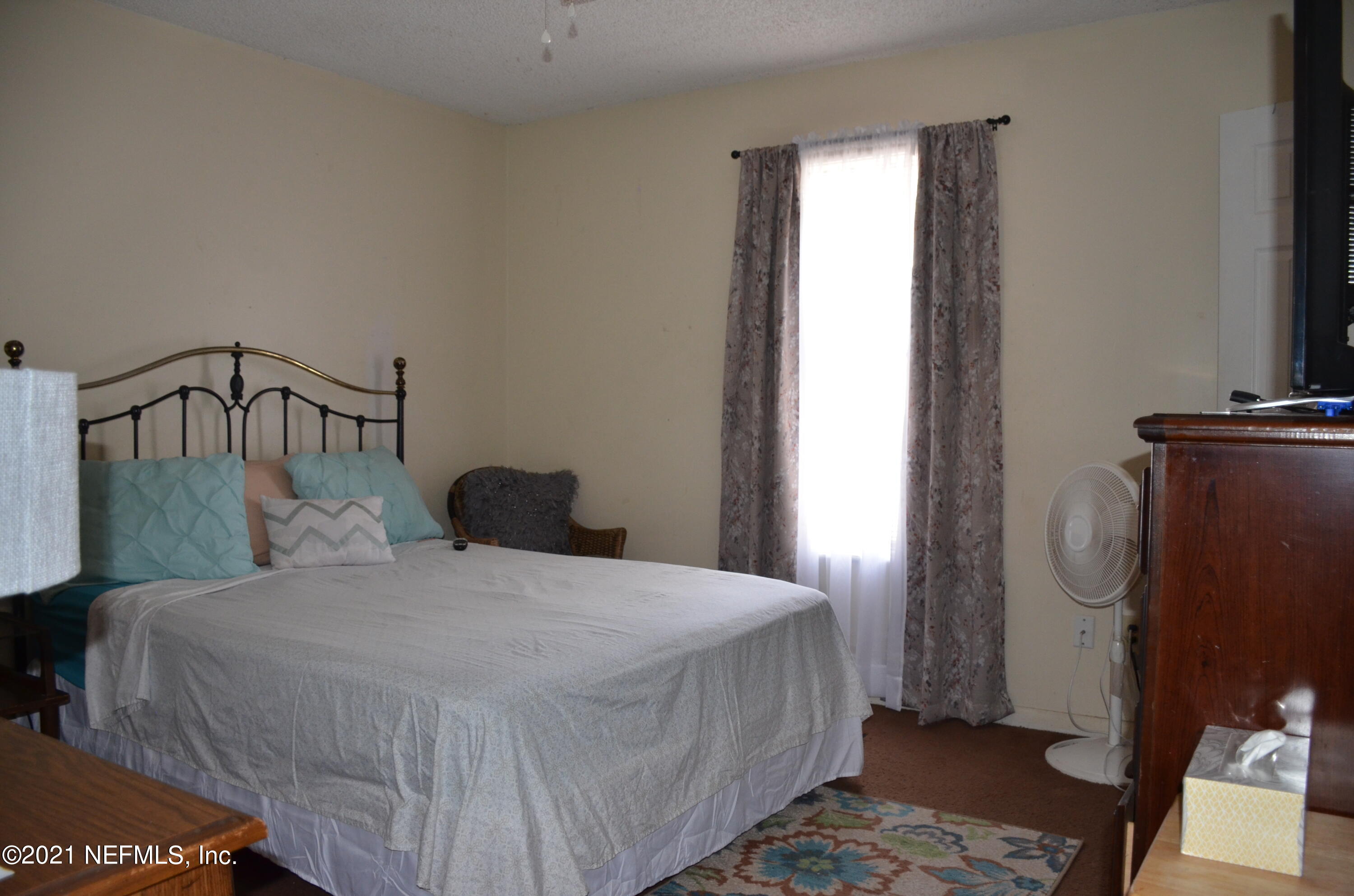 681 Rainer Road, Unit 3 Baldwin, FL 32234 - Photo 21 of 28 a bedroom with a bed and a window