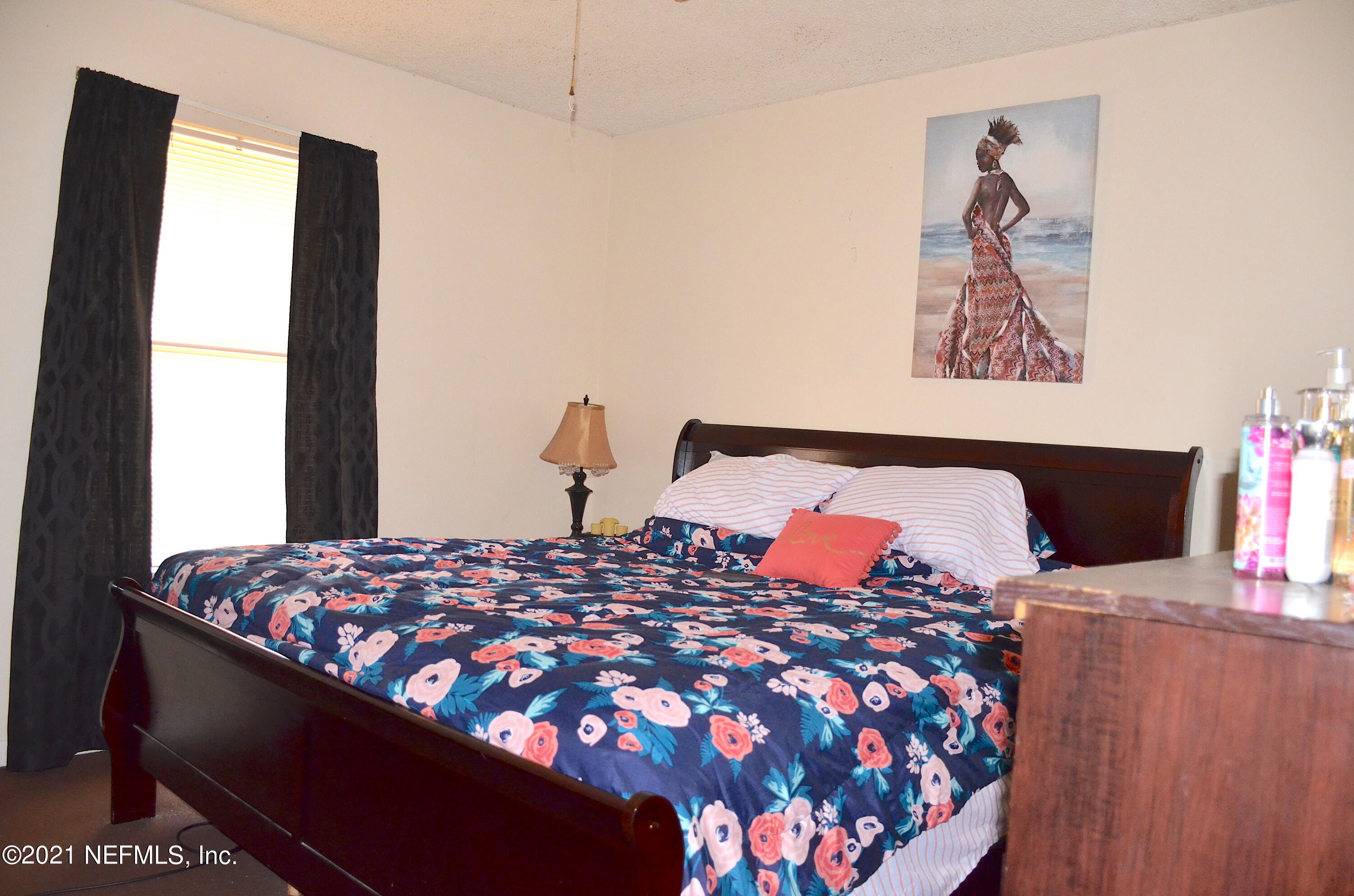 681 Rainer Road, Unit 3 Baldwin, FL 32234 - Photo 26 of 28 a bedroom with a bed and flat screen tv