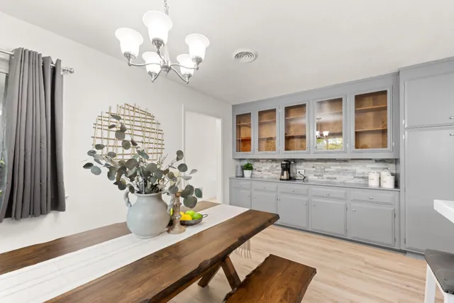 a kitchen with a table and chandelier