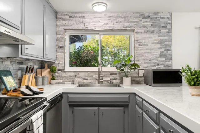 a kitchen with a sink stove and microwave