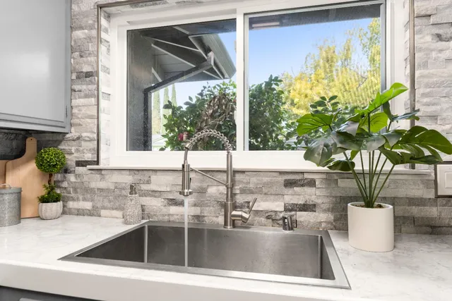 a kitchen with a sink and a granite counter top