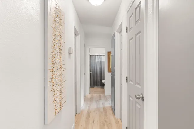 a bathroom with a granite countertop sink toilet and mirror