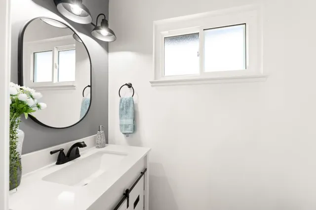 a bathroom with a sink and a mirror
