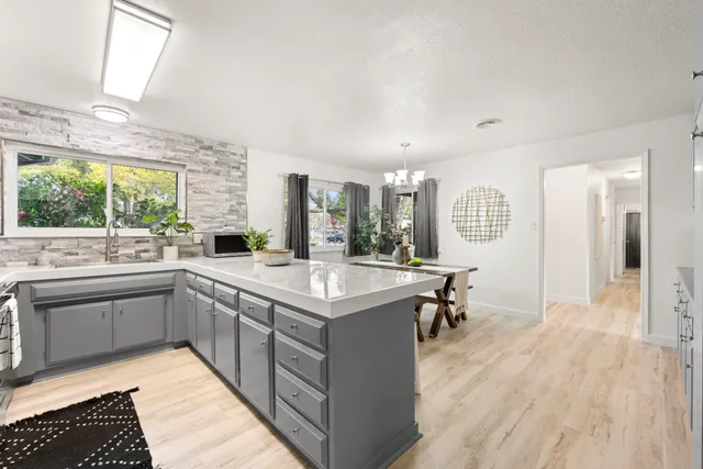 a kitchen with center island and stainless steel appliances