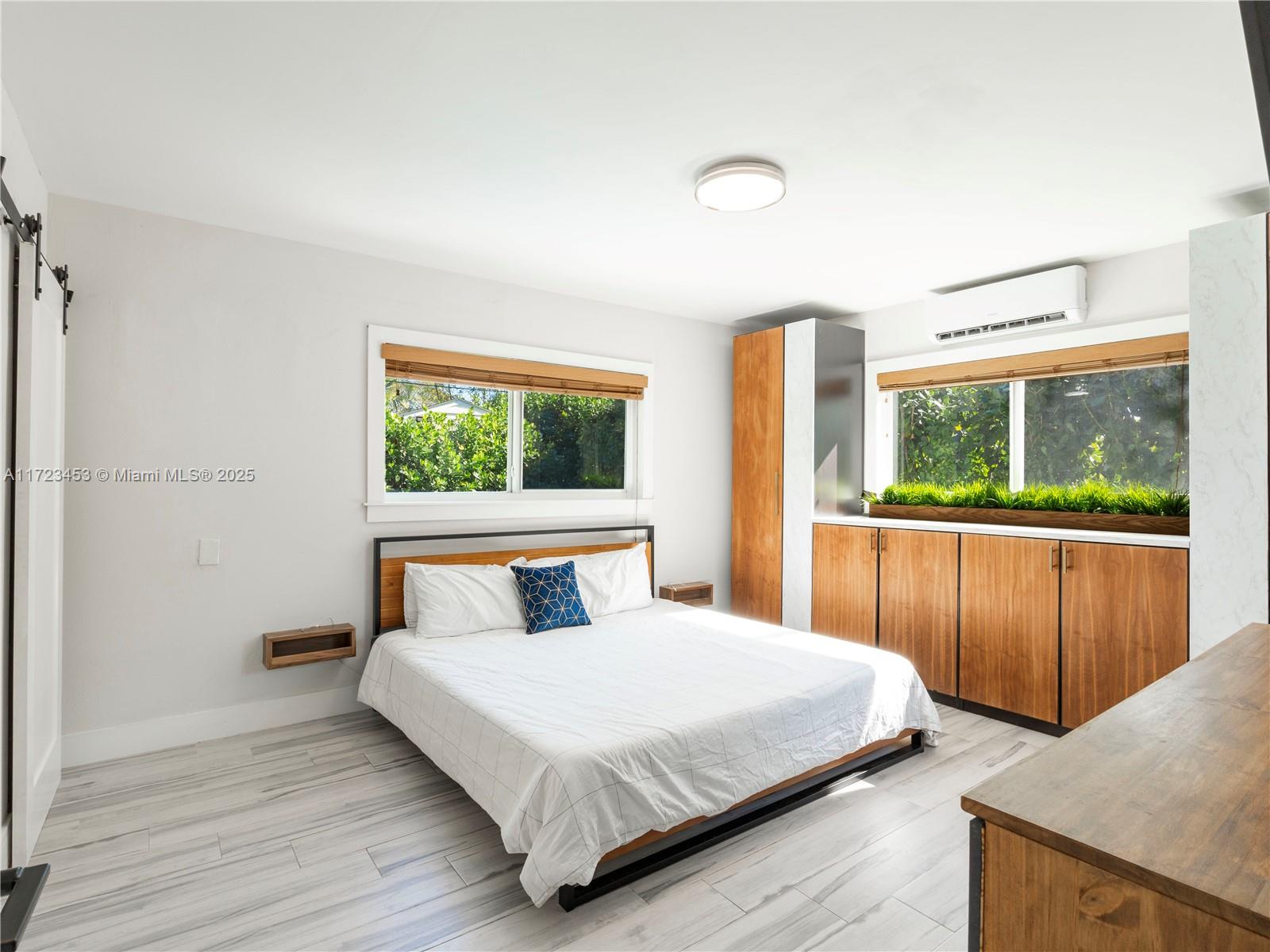 1001 Southwest 23rd Road Miami, FL 33129 - Photo 16 of 38 a bedroom with a large bed and a large window