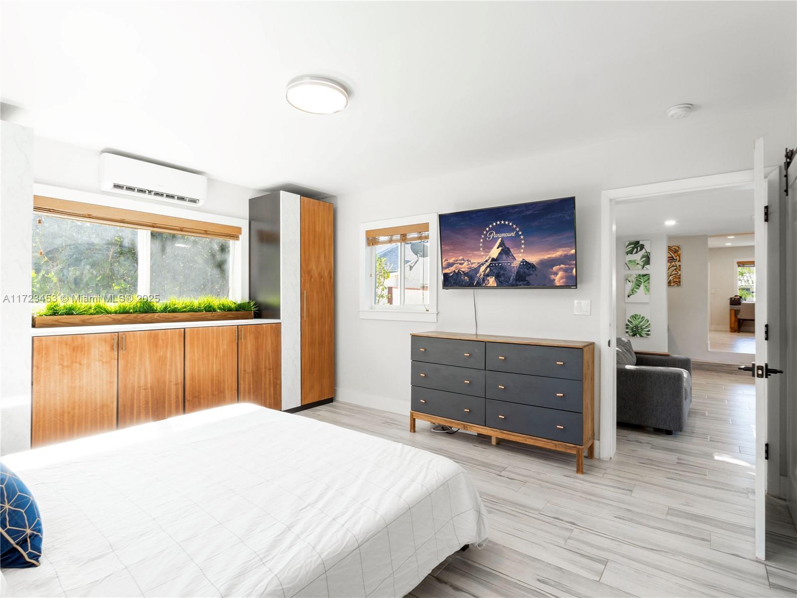 1001 Southwest 23rd Road Miami, FL 33129 - Photo 17 of 38 a bedroom with a bed and a dresser next to a window