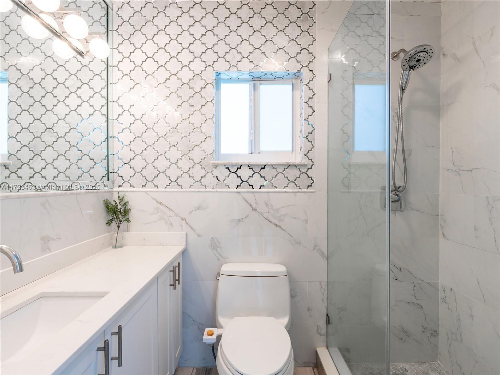 1001 Southwest 23rd Road Miami, FL 33129 - Photo 18 of 38 a bathroom with a sink a toilet and shower