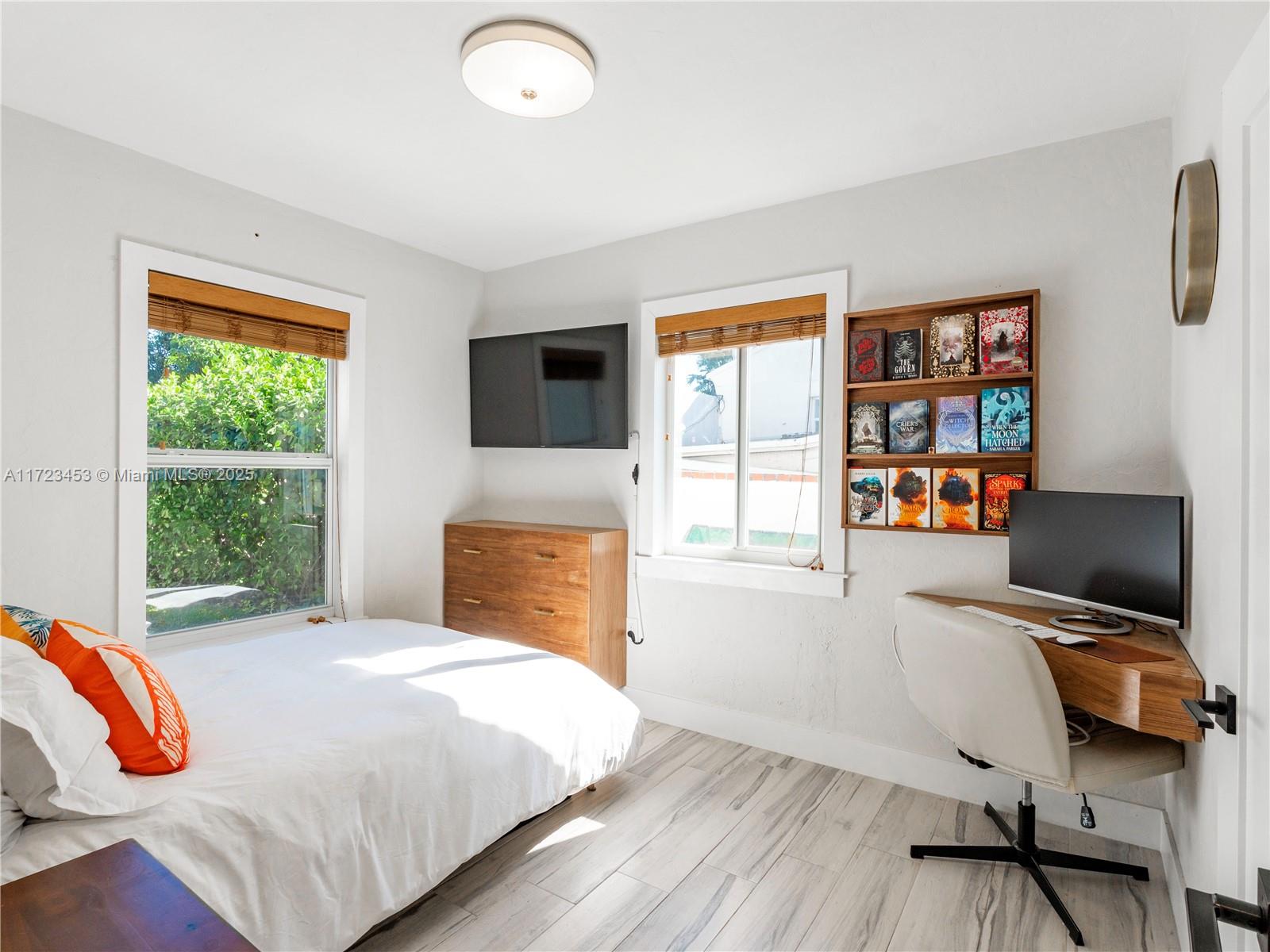 1001 Southwest 23rd Road Miami, FL 33129 - Photo 26 of 38 a bedroom with a bed and a flat screen tv