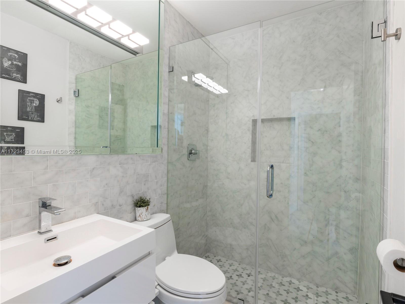 1001 Southwest 23rd Road Miami, FL 33129 - Photo 28 of 38 a bathroom with a sink a toilet and shower