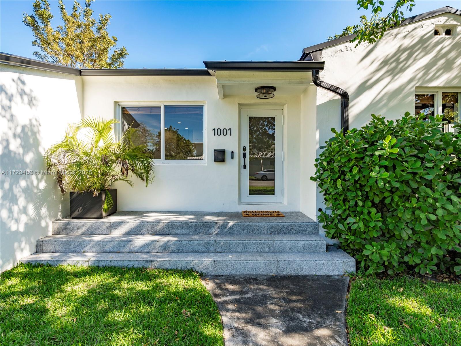 1001 Southwest 23rd Road Miami, FL 33129 - Photo 35 of 38 a front view of a house with a yard