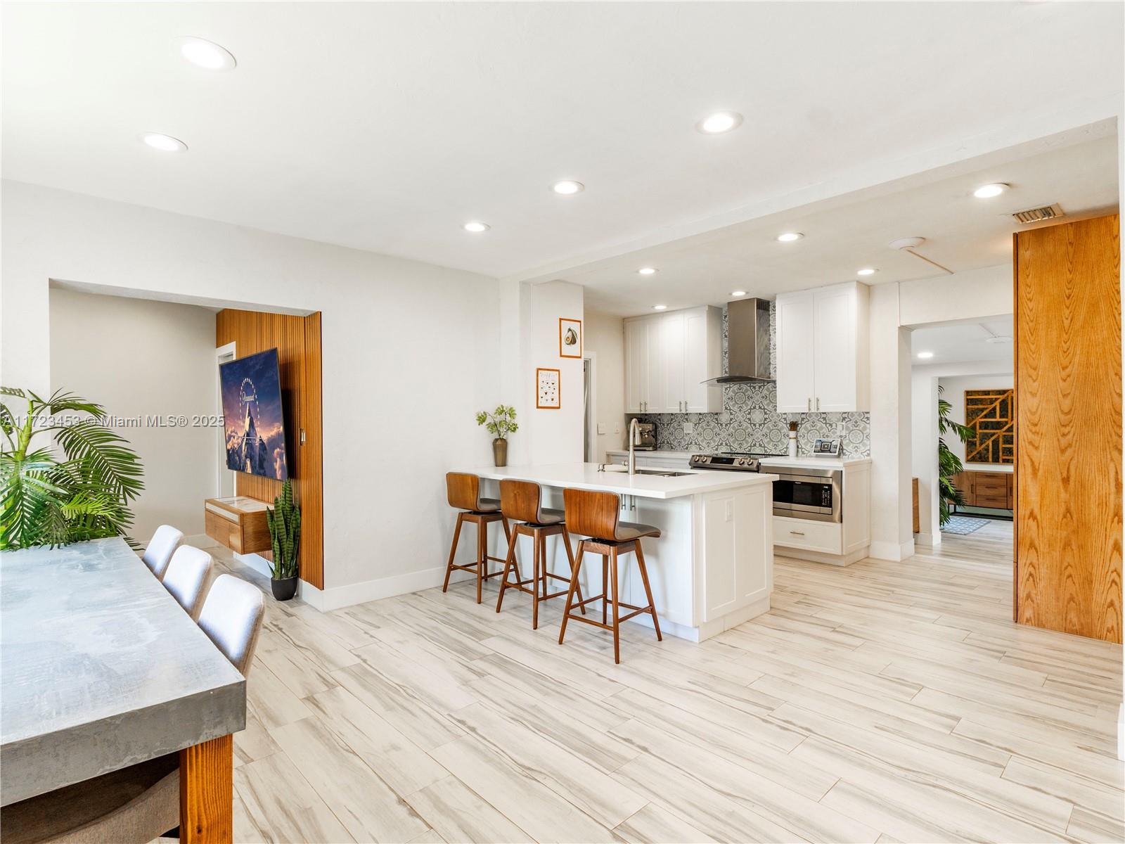1001 Southwest 23rd Road Miami, FL 33129 - Photo 4 of 38 a open kitchen with white cabinets and stainless steel appliances