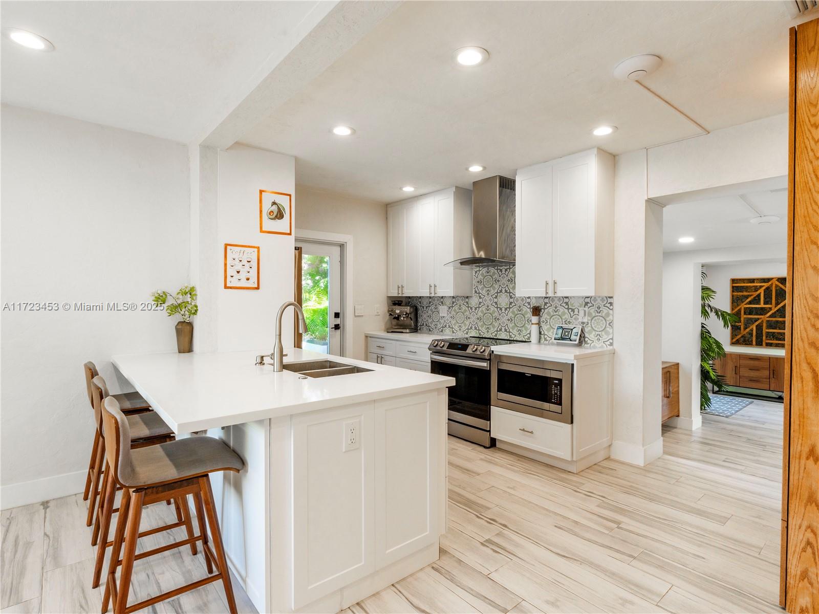 1001 Southwest 23rd Road Miami, FL 33129 - Photo 7 of 38 a kitchen with white cabinets and appliances