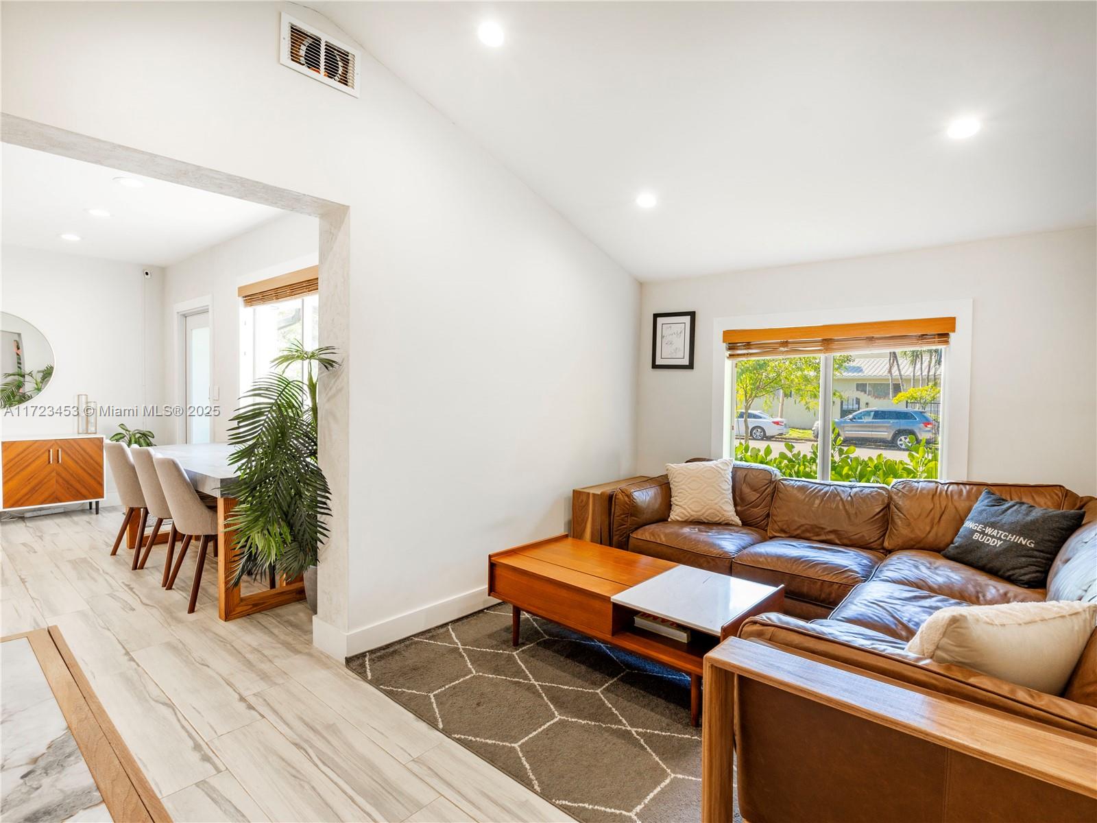 1001 Southwest 23rd Road Miami, FL 33129 - Photo 10 of 38 a living room with furniture a wooden floor and a potted plant