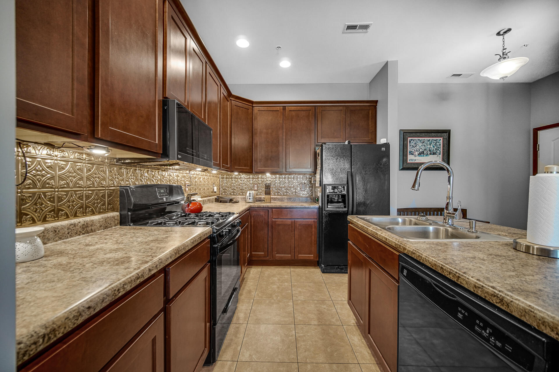 123 North Main Street, Unit 301 Crown Point, IN 46307 - Photo 9 of 25 a kitchen with stainless steel appliances granite countertop a sink stove and refrigerator